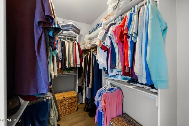 a view of walk in closet with clothes