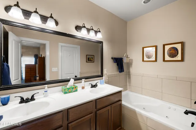 a bathroom with a bathtub sink and mirror