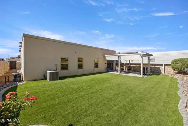 a view of a backyard with plants and a patio