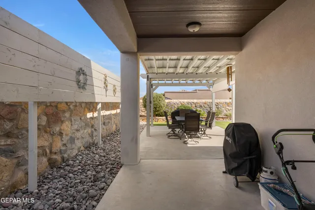 a view of a porch with furniture and floor to ceiling window