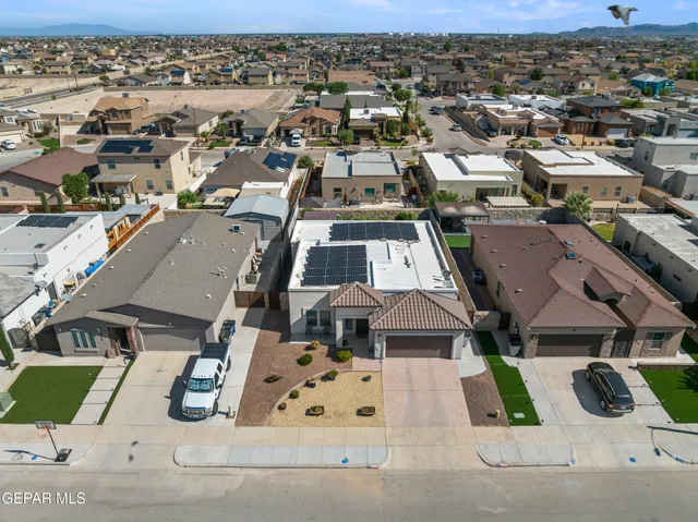 an aerial view of residential houses with outdoor space