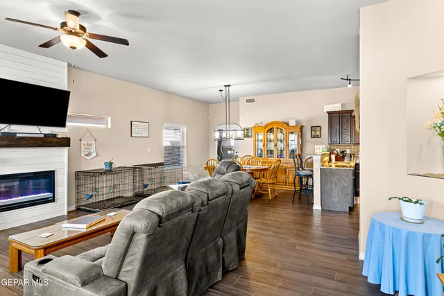 a living room with furniture fireplace and flat screen tv