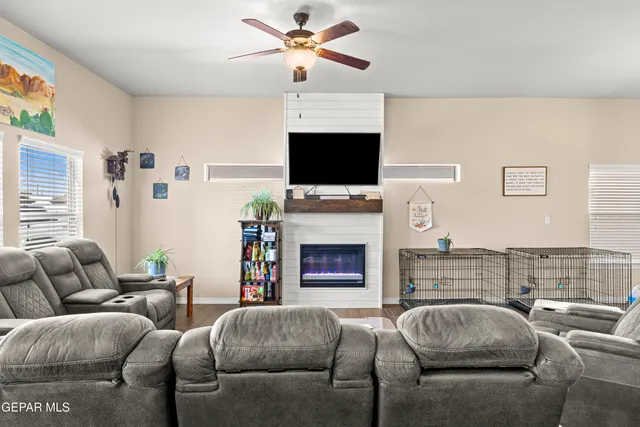 a living room with furniture a flat screen tv and a fireplace