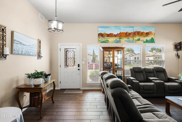 a living room with furniture a window and a chandelier