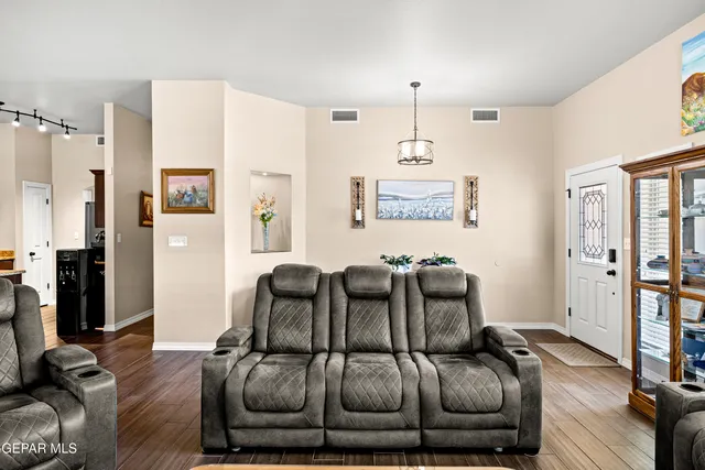 a bedroom with furniture and a wooden floor
