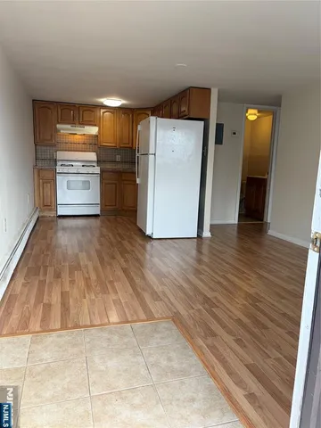 a view of a kitchen with a sink and a refrigerator