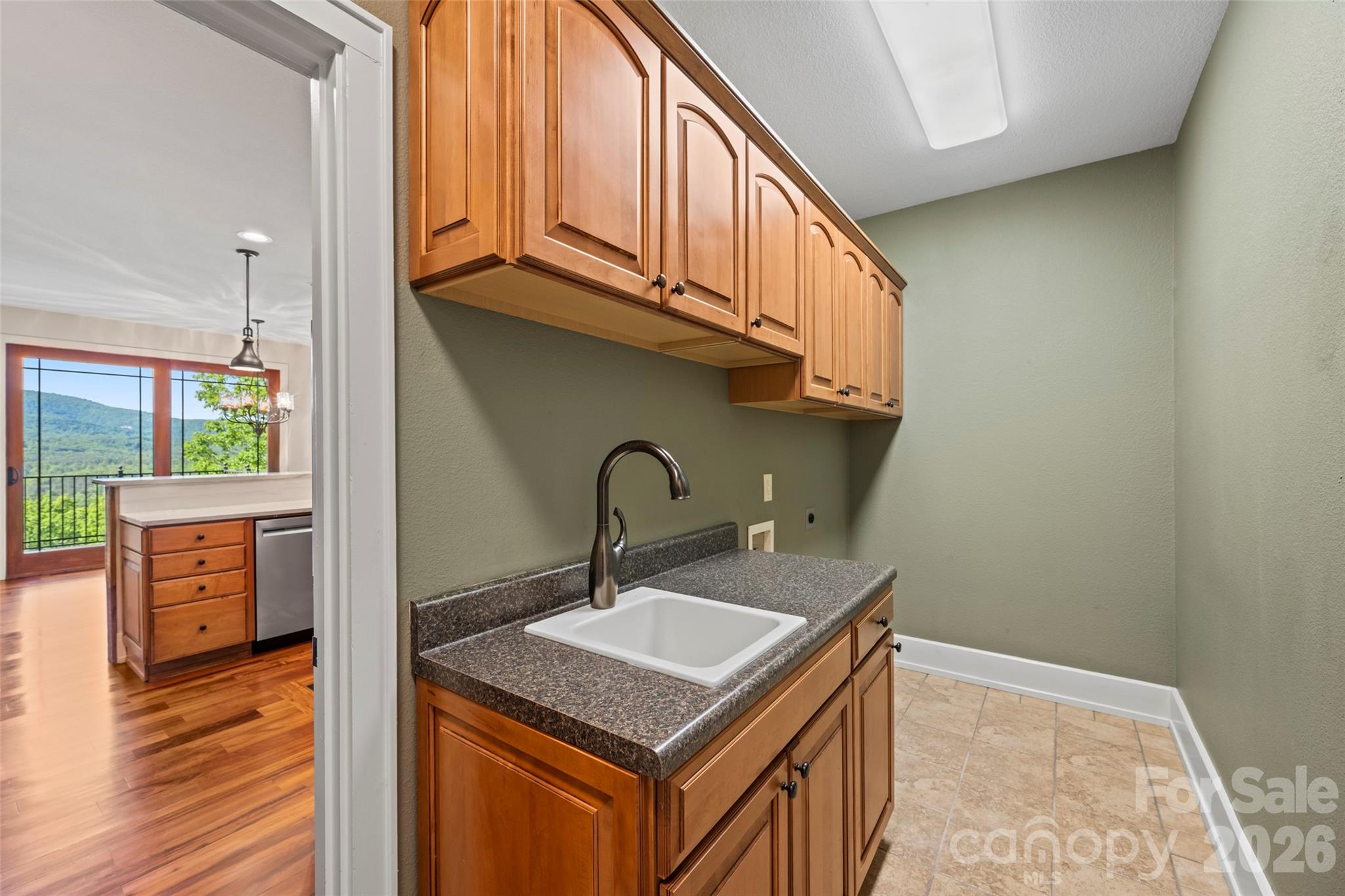 556 High Pines Loop Lake Lure, NC 28746 - Photo 17 of 46 a kitchen with stainless steel appliances granite countertop a sink and a stove next to a window