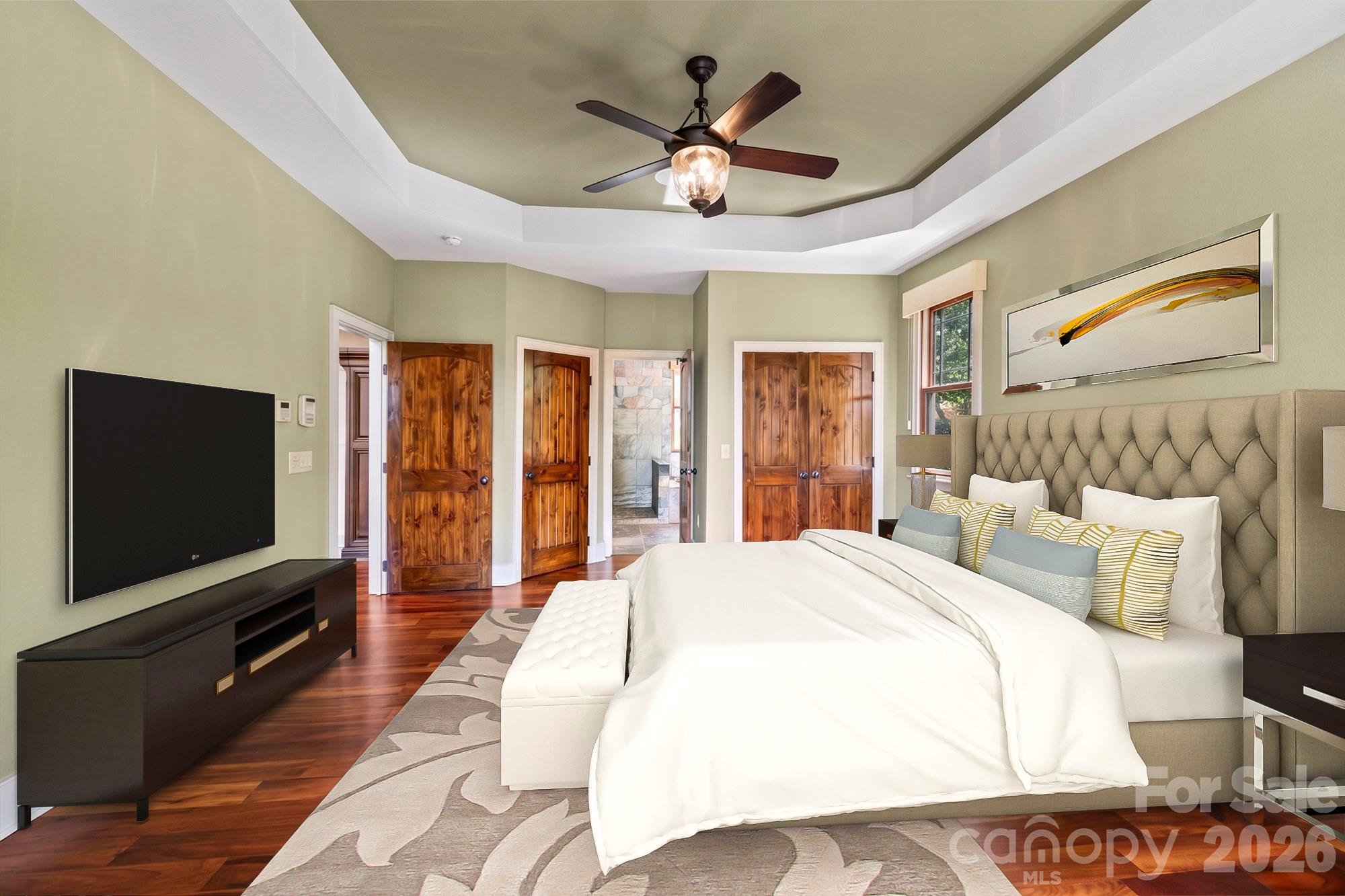 556 High Pines Loop Lake Lure, NC 28746 - Photo 18 of 46 a spacious bedroom with a bed and a flat screen tv