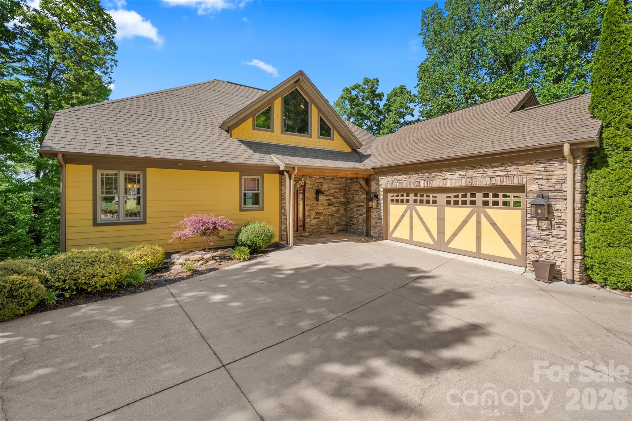 556 High Pines Loop Lake Lure, NC 28746 - Photo 2 of 46 a front view of a house with garden