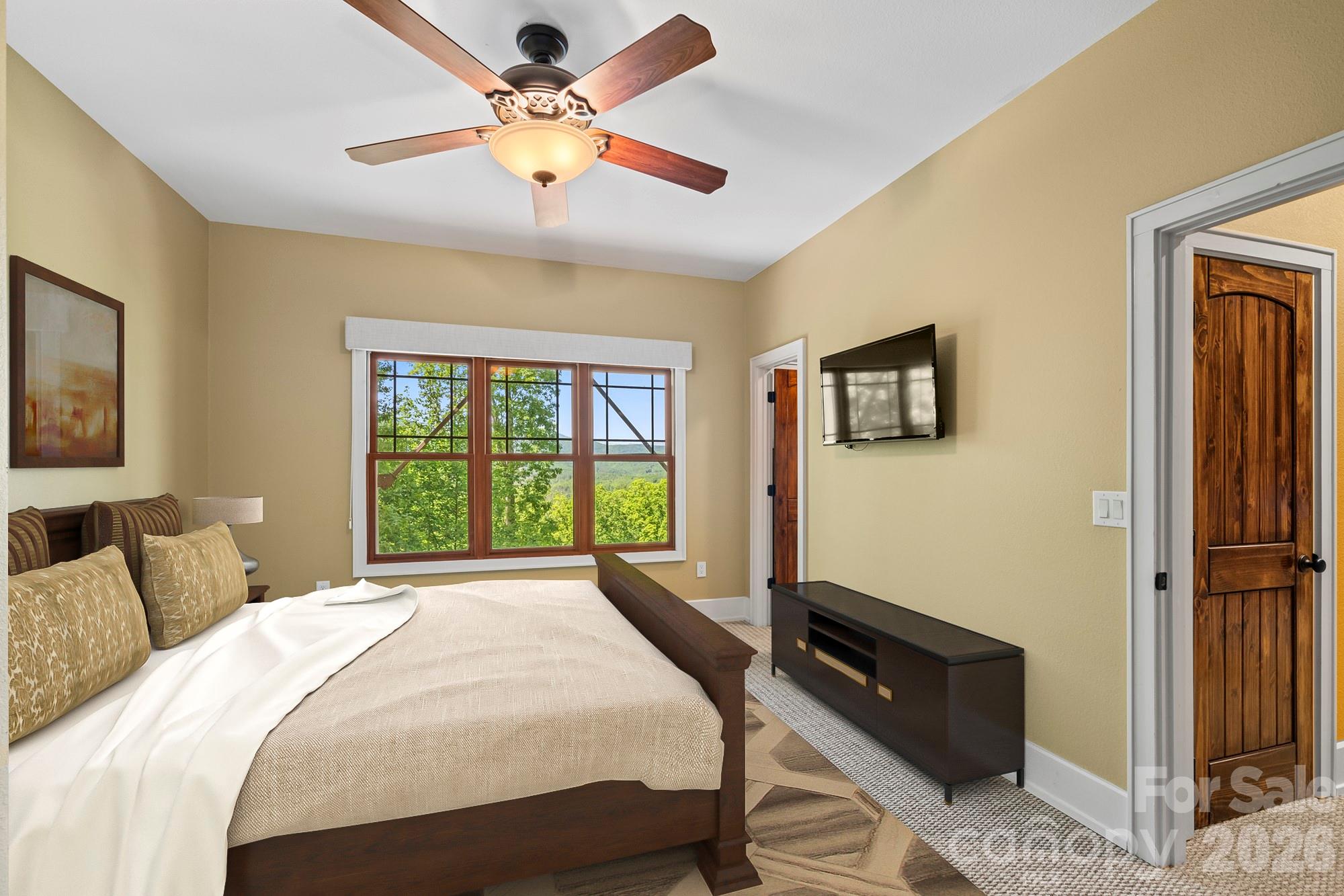 556 High Pines Loop Lake Lure, NC 28746 - Photo 28 of 46 a bedroom with a bed dresser and a window