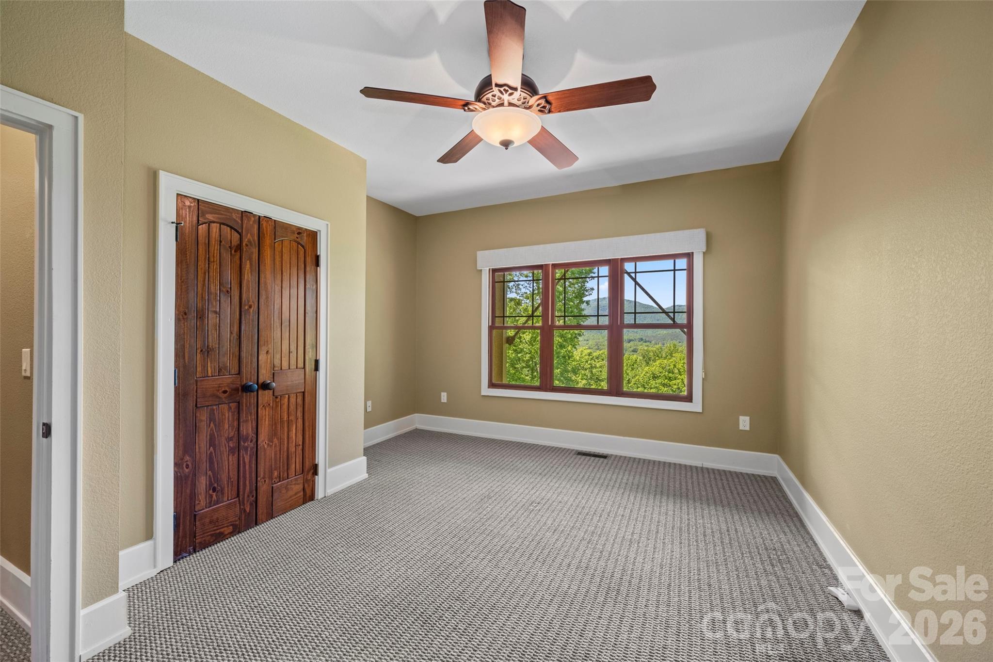 556 High Pines Loop Lake Lure, NC 28746 - Photo 29 of 46 a view of n empty room with window and a ceiling fan