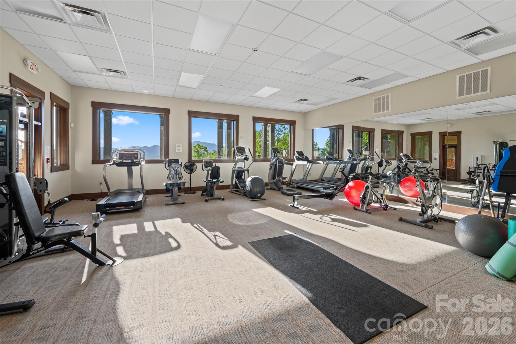 556 High Pines Loop Lake Lure, NC 28746 - Photo 45 of 46 a living room with furniture gym equipment and a large window