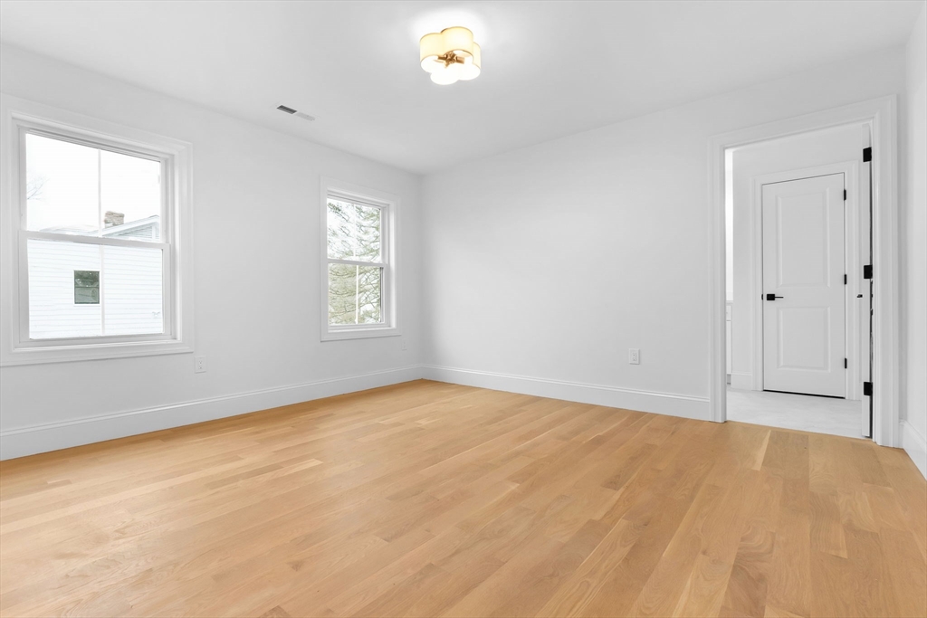 11 Couture Way Middleton, MA 01949 - Photo 18 of 24 a view of an empty room with a window and a kitchen