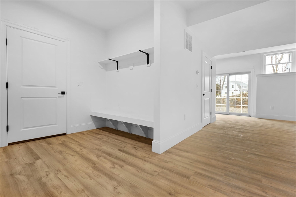 11 Couture Way Middleton, MA 01949 - Photo 23 of 24 a view of an empty room with wooden floor and a window