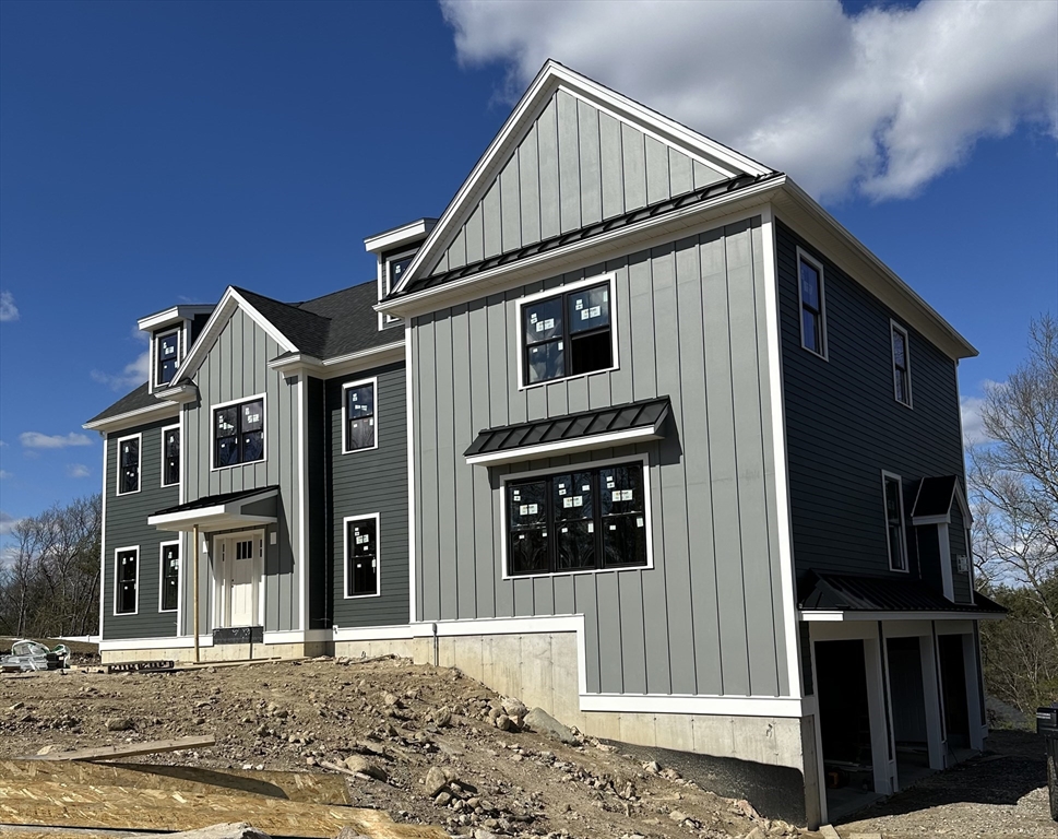 11 Couture Way Middleton, MA 01949 - Photo 3 of 24 a front view of a house with a small yard