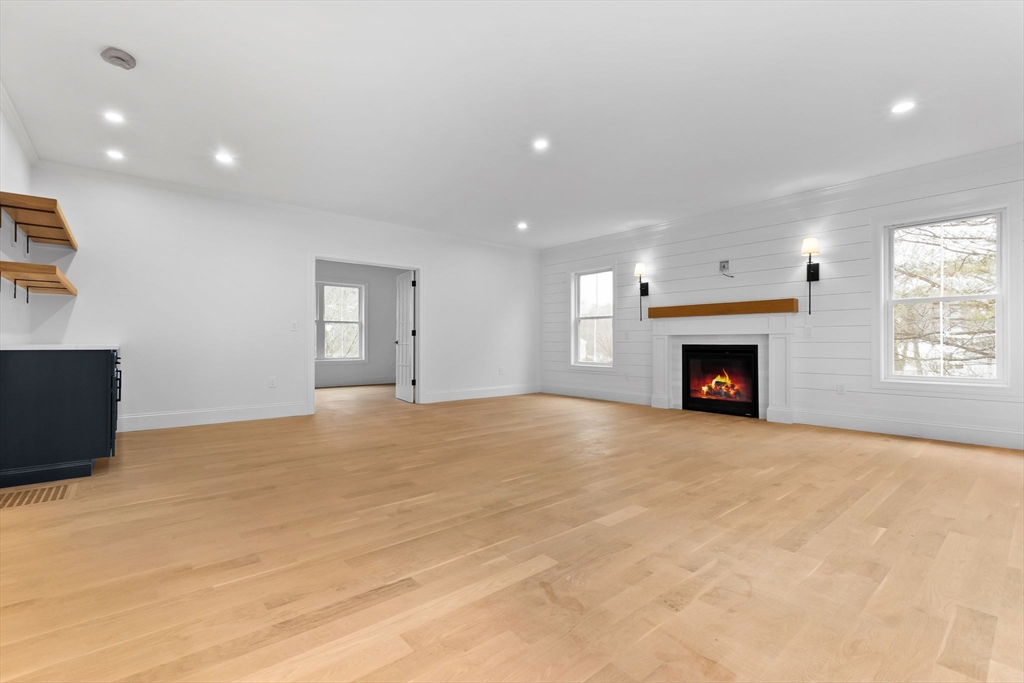 11 Couture Way Middleton, MA 01949 - Photo 7 of 24 a view of an empty room with a fireplace