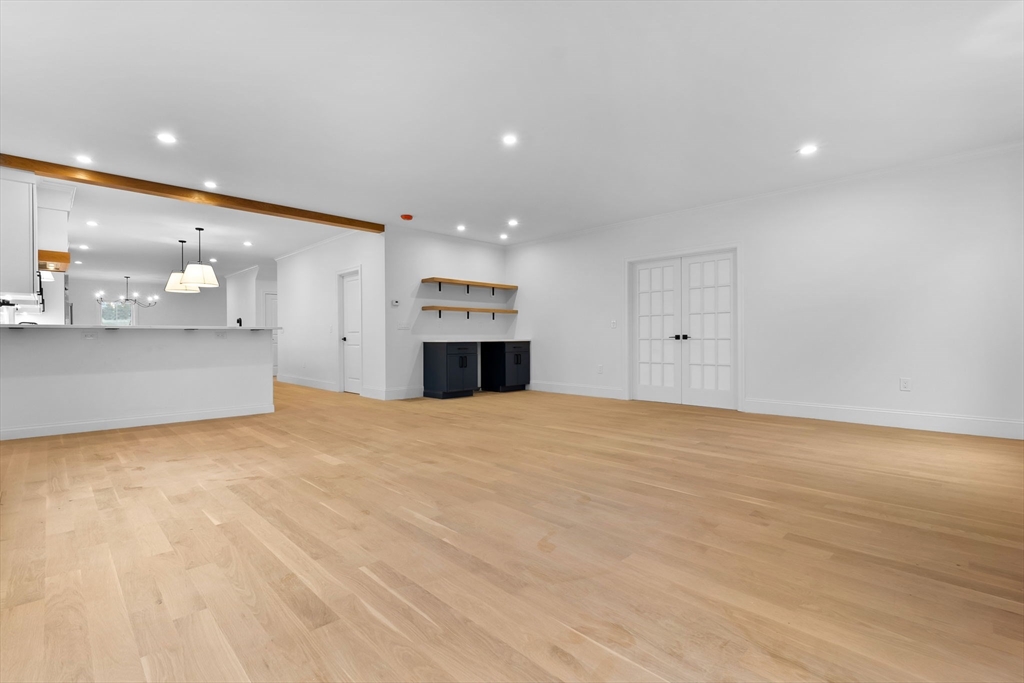 11 Couture Way Middleton, MA 01949 - Photo 8 of 24 a view of empty room with kitchen and window