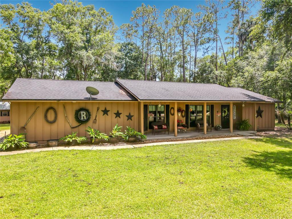 1395 Maytown Road Osteen, FL 32764 - Photo 3 of 65 a front view of house with yard and trees in the background