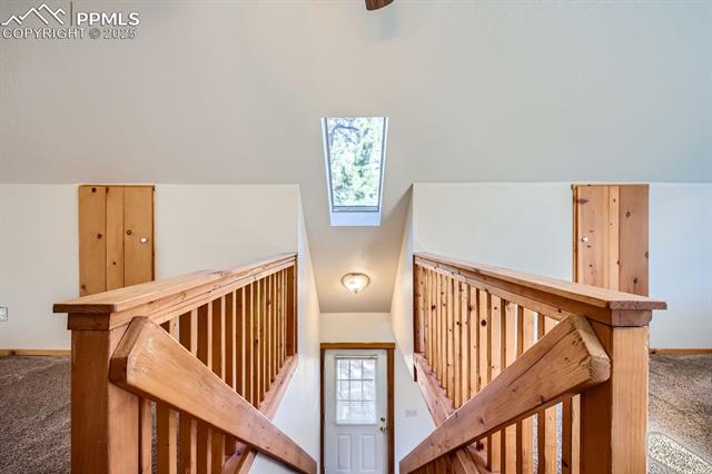 365 Alpine View Road Divide, CO 80814 - Photo 18 of 26 Stairway featuring vaulted ceiling and carpet