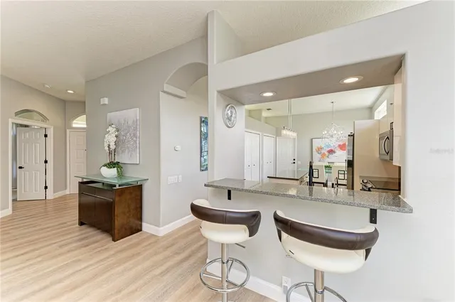 a view of a dining room with furniture a chandelier and wooden floor