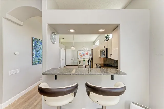 a view of a chairs and fire pit in the balcony