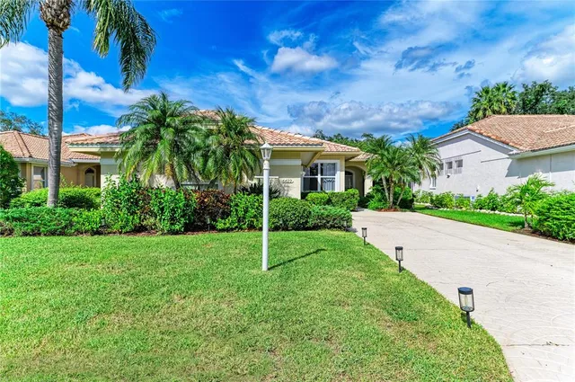 an aerial view of a house with a yard and garden