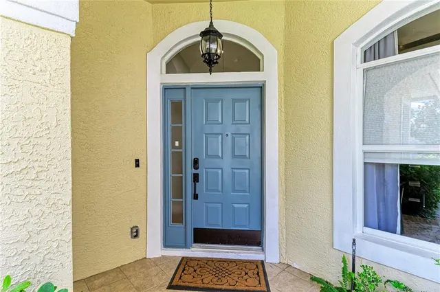 a living room with fireplace furniture and a large window
