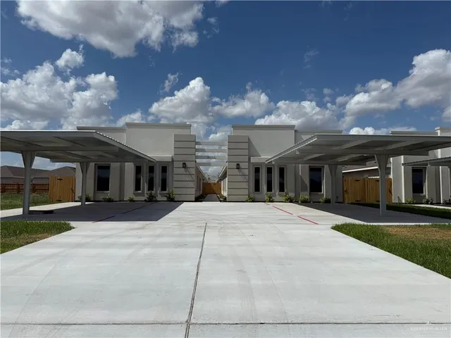 a front view of a house with a yard and a garage