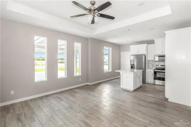 a view of a livingroom with a ceiling fan and window