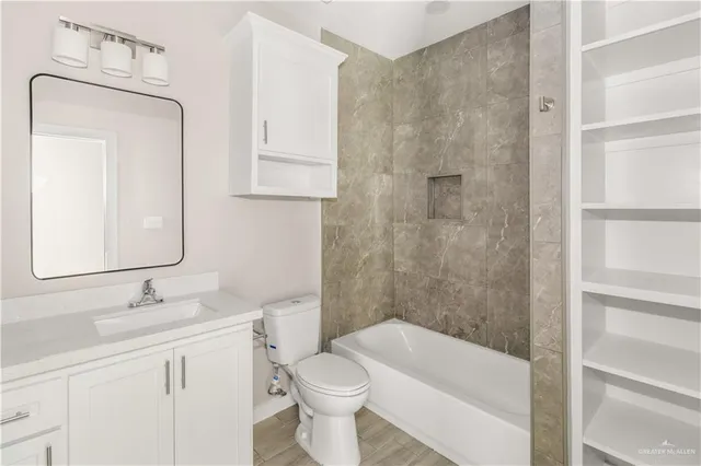 an empty room with a window and a ceiling fan