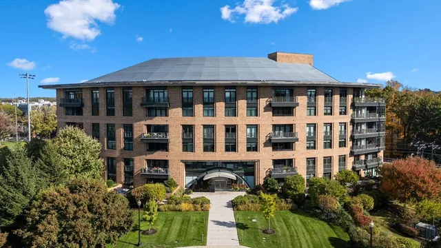 a front view of a building with a garden