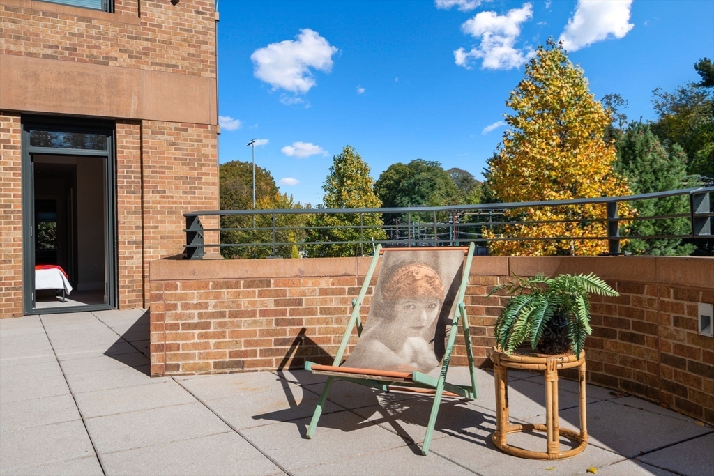 2400 Beacon Street, Unit 112 Boston, MA 02467 - Photo 16 of 21 a view of a chairs and table in the balcony