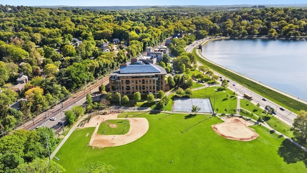 2400 Beacon Street, Unit 112 Boston, MA 02467 - Photo 21 of 21 an aerial view of a house with a garden and lake view