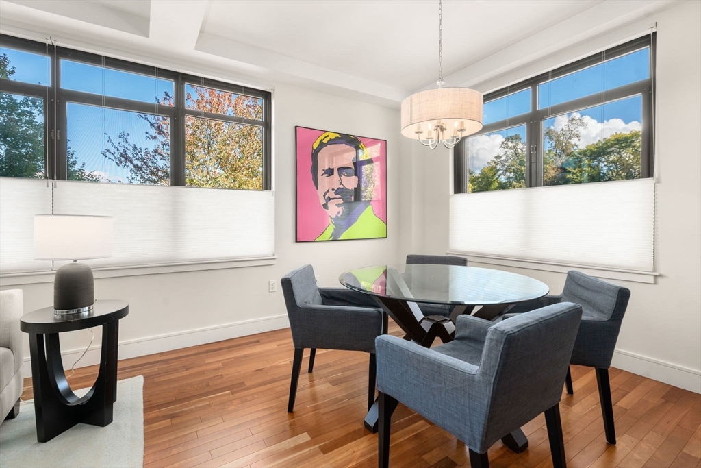 2400 Beacon Street, Unit 112 Boston, MA 02467 - Photo 6 of 21 a view of a dining room with furniture window and wooden floor