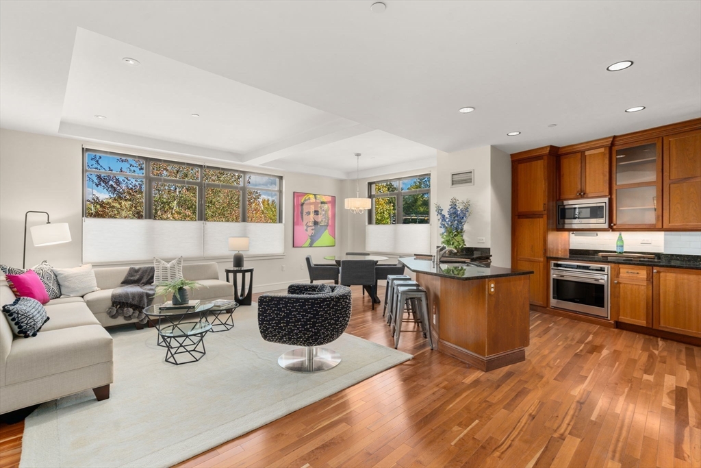 2400 Beacon Street, Unit 112 Boston, MA 02467 - Photo 7 of 21 a living room with fireplace furniture and a wooden floor