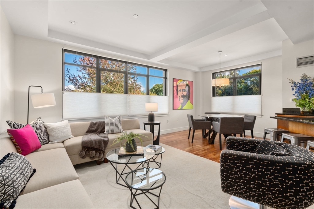 2400 Beacon Street, Unit 112 Boston, MA 02467 - Photo 9 of 21 a living room with furniture a rug and a large window