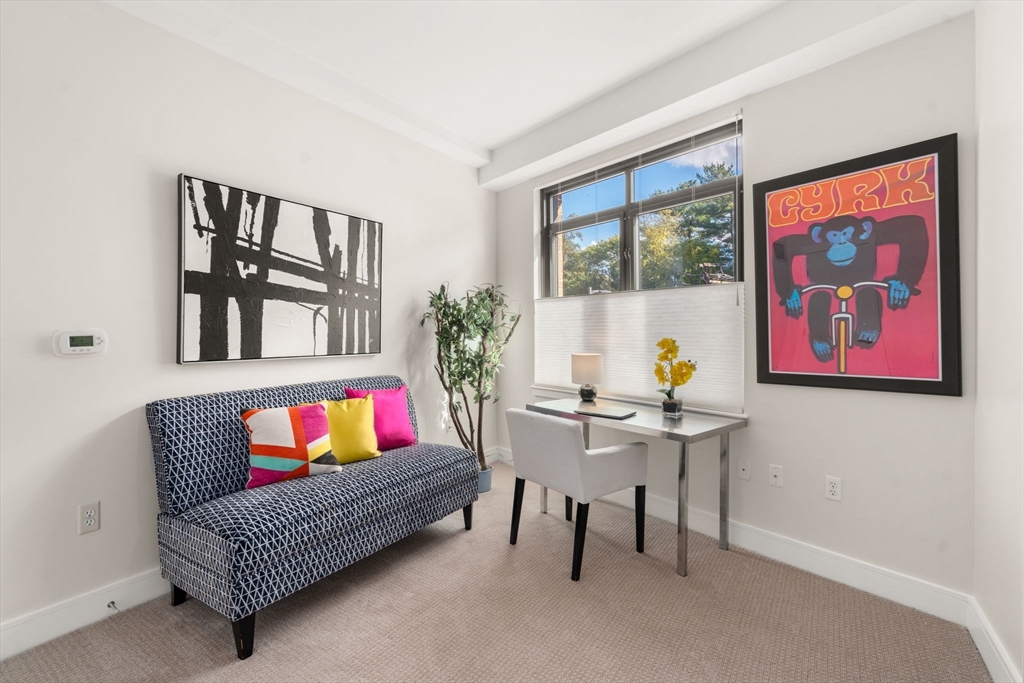 2400 Beacon Street, Unit 112 Boston, MA 02467 - Photo 10 of 21 a living room with furniture and a painting on the wall