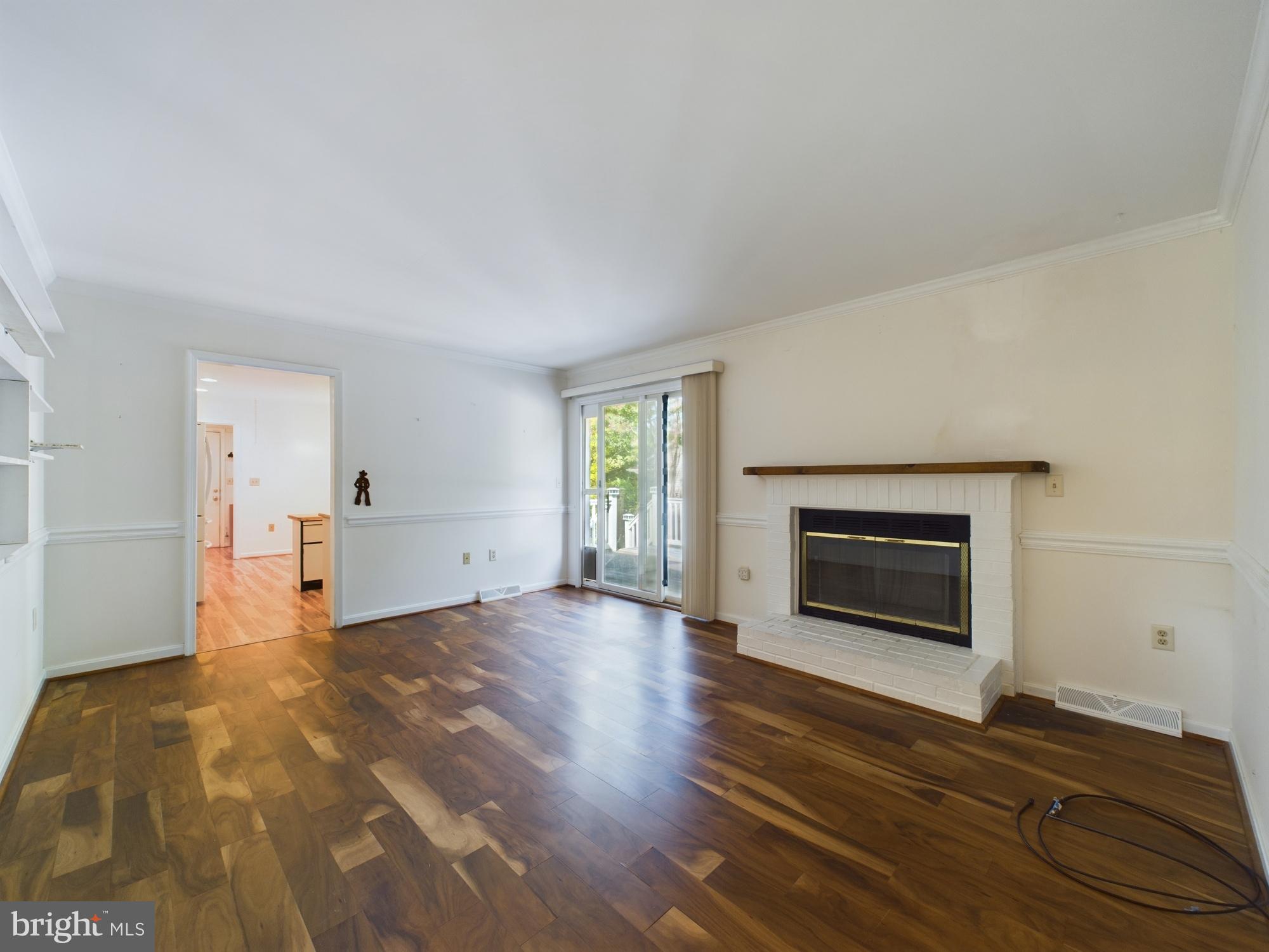 103 Birchfield Drive Dover, DE 19904 - Photo 12 of 44 a view of empty room with wooden floor and fireplace