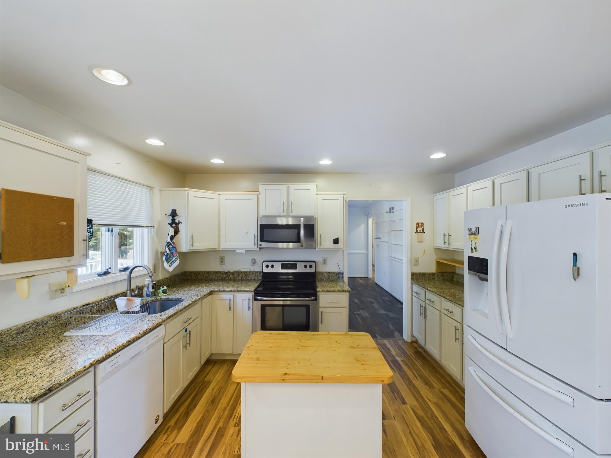 103 Birchfield Drive Dover, DE 19904 - Photo 15 of 44 a kitchen with kitchen island a sink stove and refrigerator