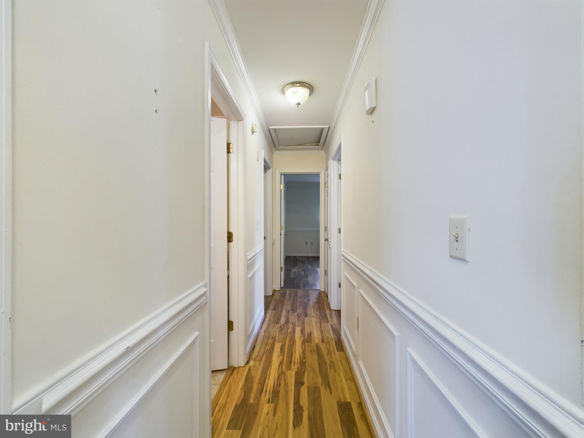 103 Birchfield Drive Dover, DE 19904 - Photo 18 of 44 a view of a hallway with wooden floor and staircase