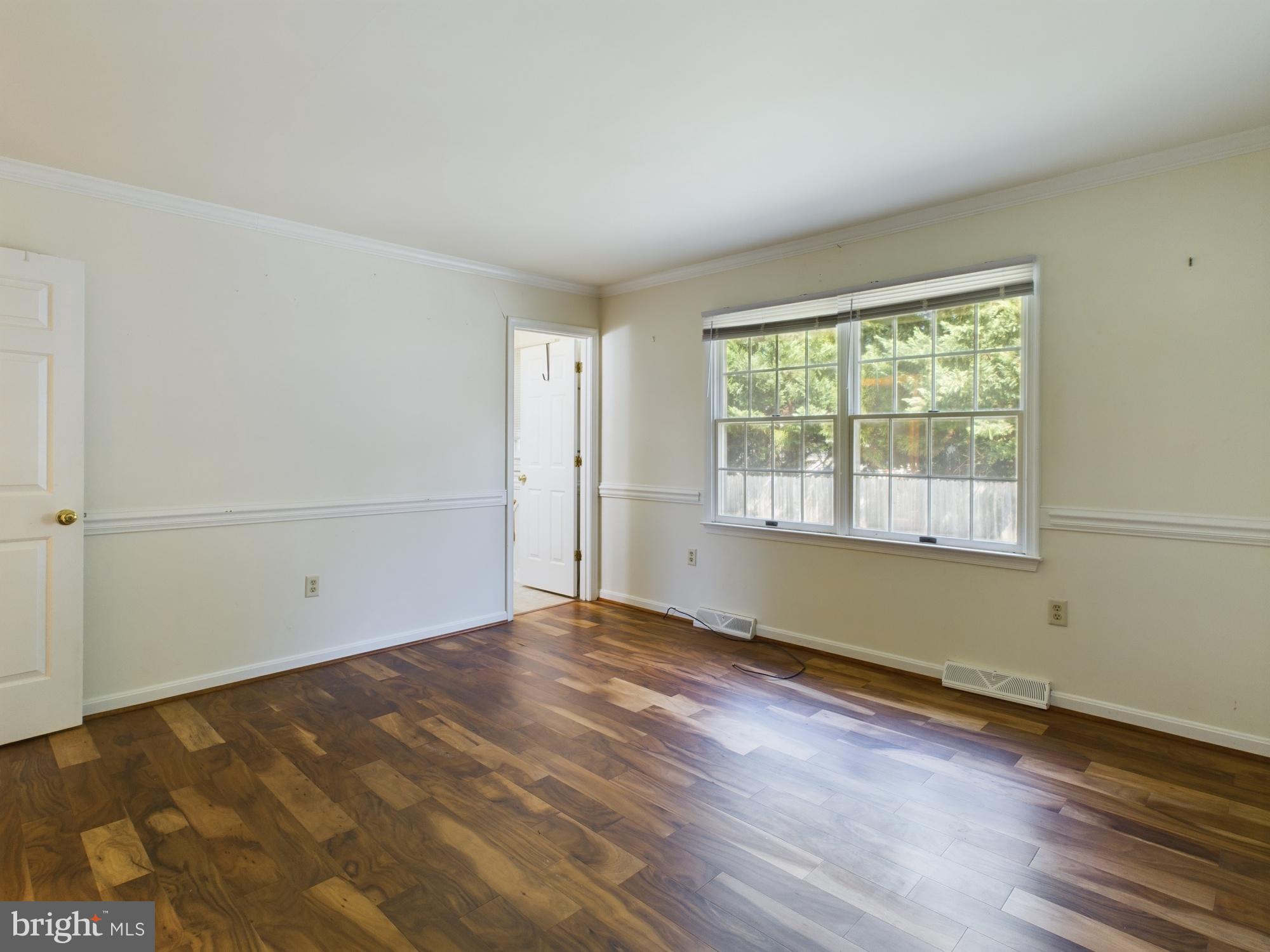 103 Birchfield Drive Dover, DE 19904 - Photo 22 of 44 an empty room with wooden floor and windows