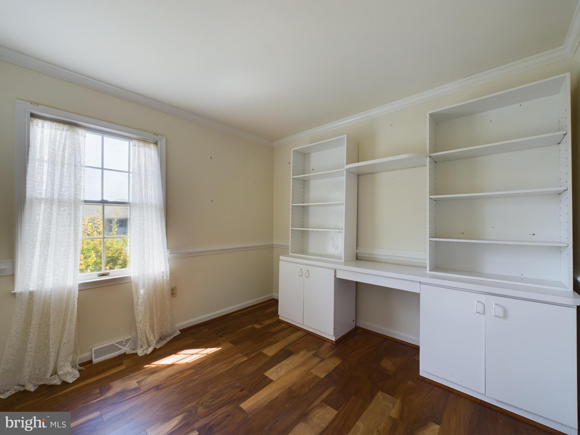 103 Birchfield Drive Dover, DE 19904 - Photo 25 of 44 a view of an empty room with a window and wooden floor