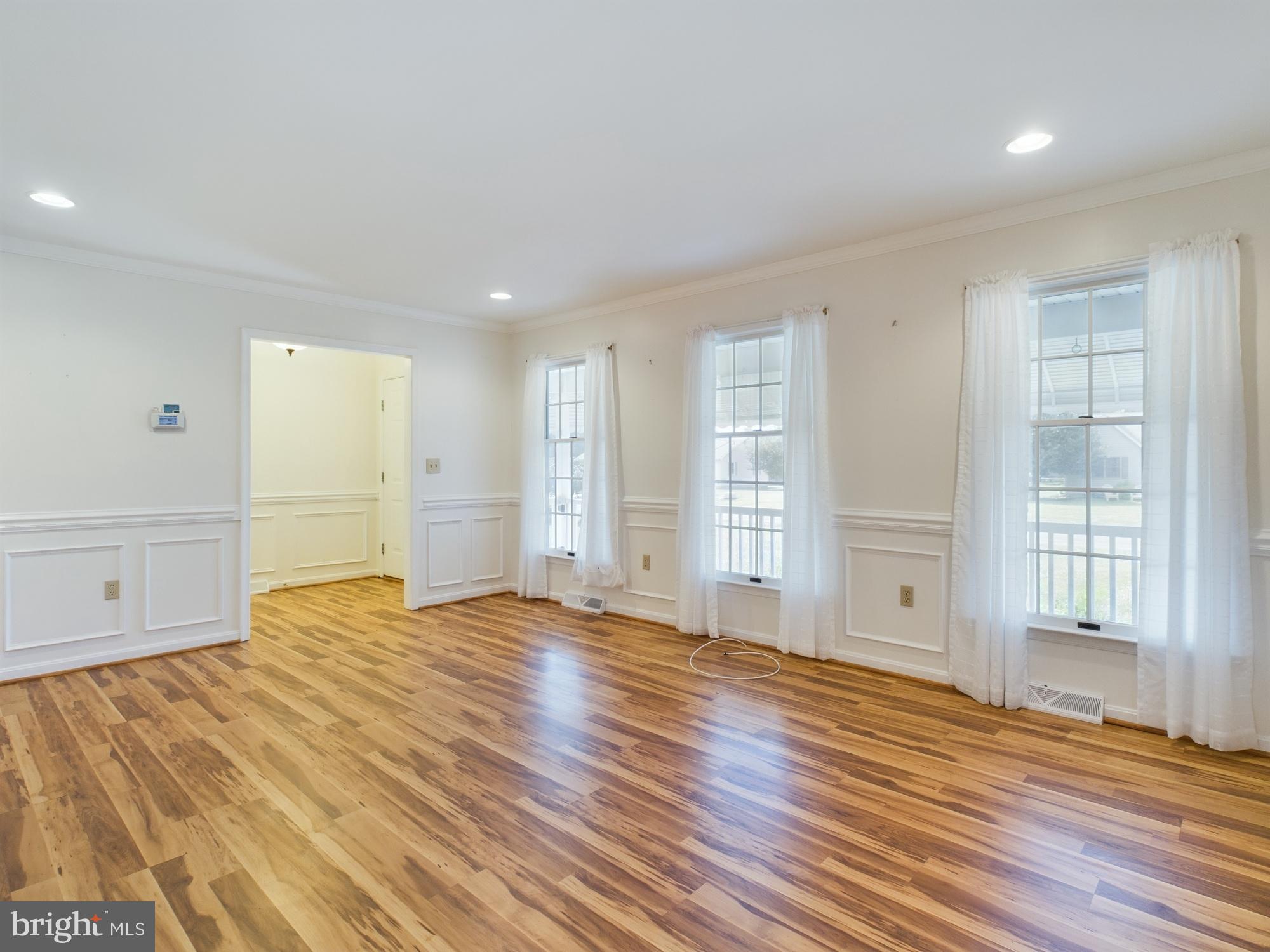 103 Birchfield Drive Dover, DE 19904 - Photo 9 of 44 a view of empty room with wooden floor and fan