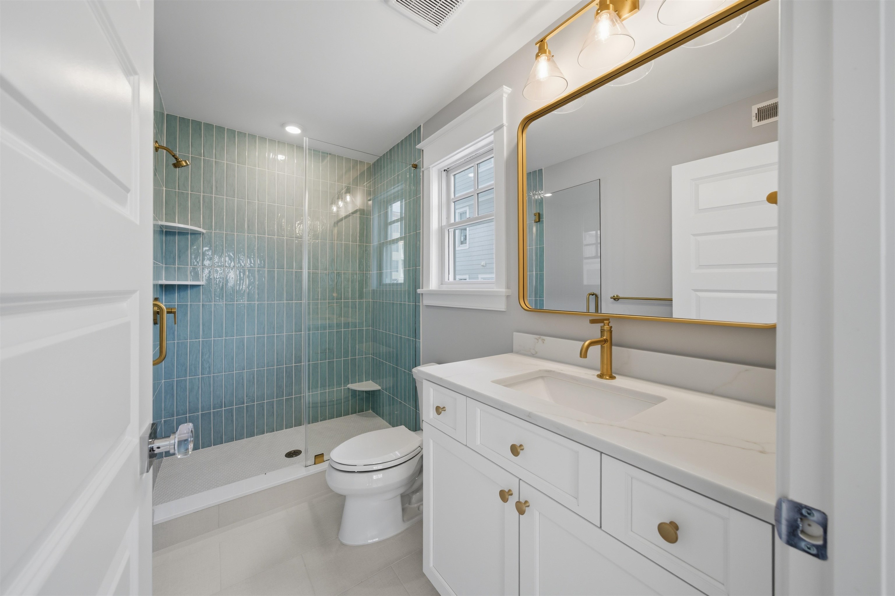 135 7th Street Avalon, NJ 08202 - Photo 29 of 50 a bathroom with a sink a toilet and shower