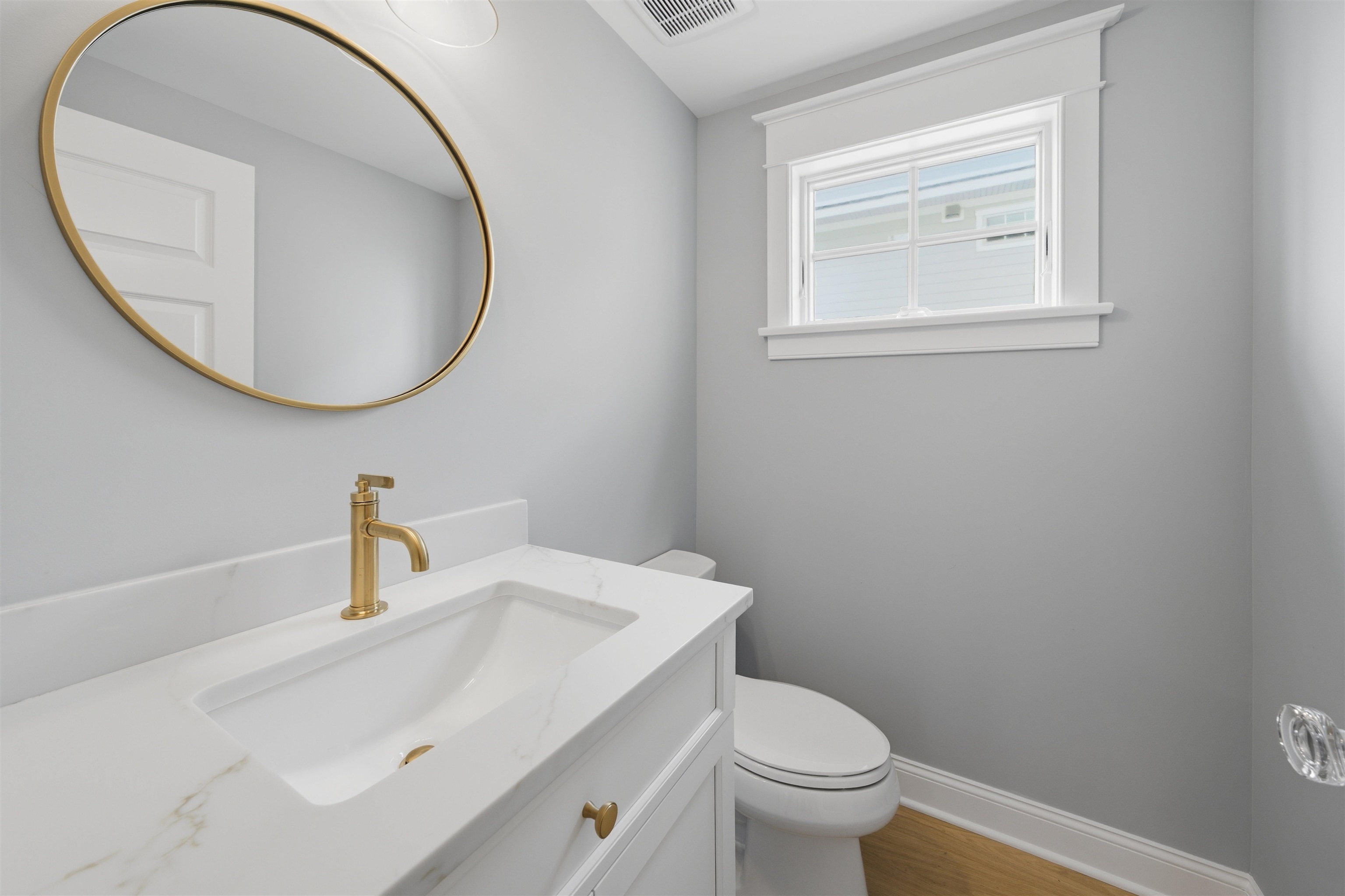 135 7th Street Avalon, NJ 08202 - Photo 32 of 50 a bathroom with a toilet a sink a mirror and vanity