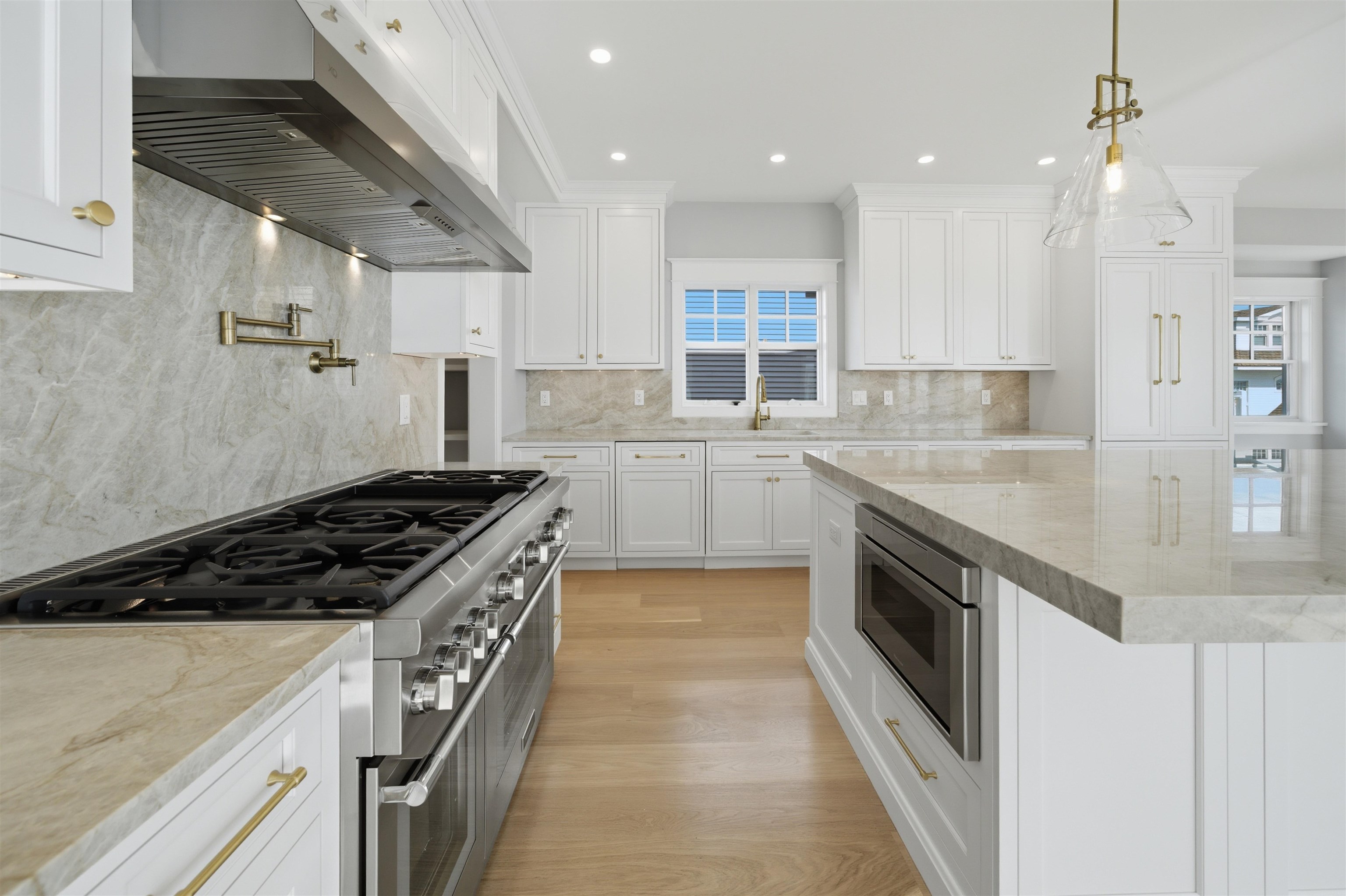 135 7th Street Avalon, NJ 08202 - Photo 8 of 50 a kitchen with granite countertop a sink stove and cabinets