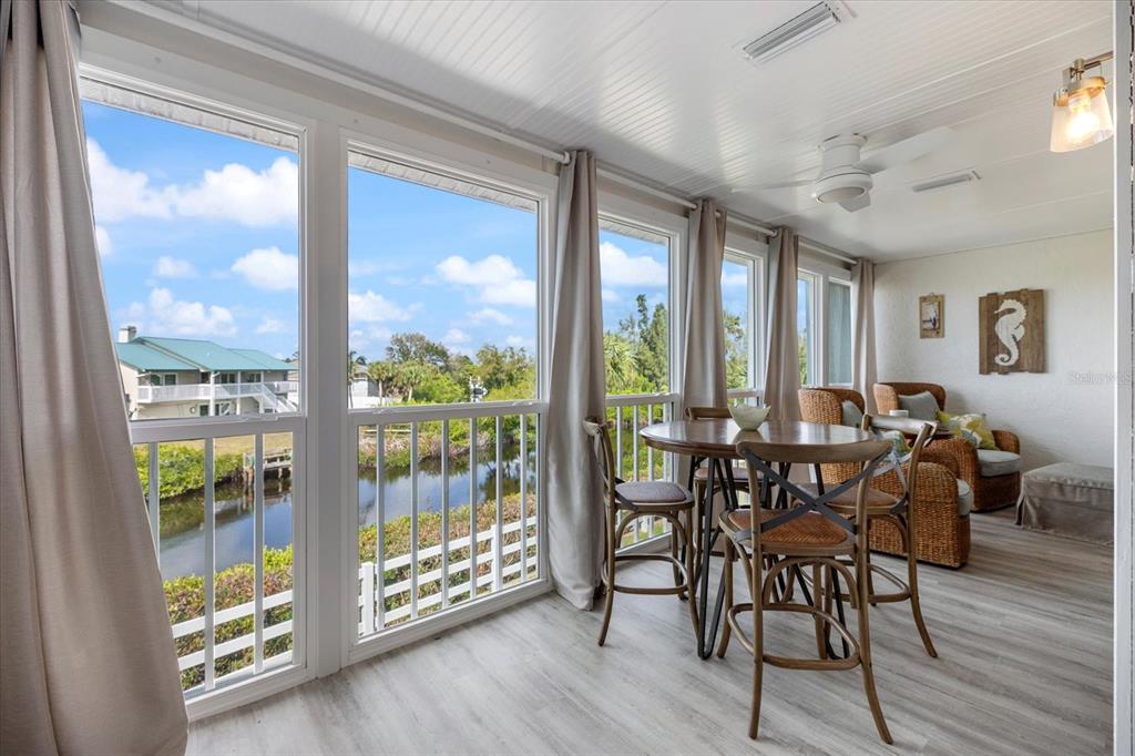 841 Waterside Drive, Unit 202 Venice, FL 34285 - Photo 14 of 43 a view of a dining room with furniture window and wooden floor