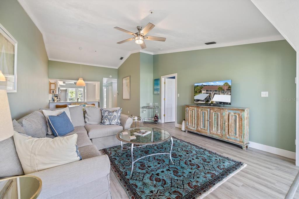 841 Waterside Drive, Unit 202 Venice, FL 34285 - Photo 17 of 43 a living room with furniture and wooden floor