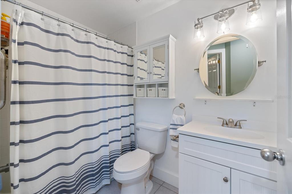 841 Waterside Drive, Unit 202 Venice, FL 34285 - Photo 24 of 43 a bathroom with a toilet sink and mirror