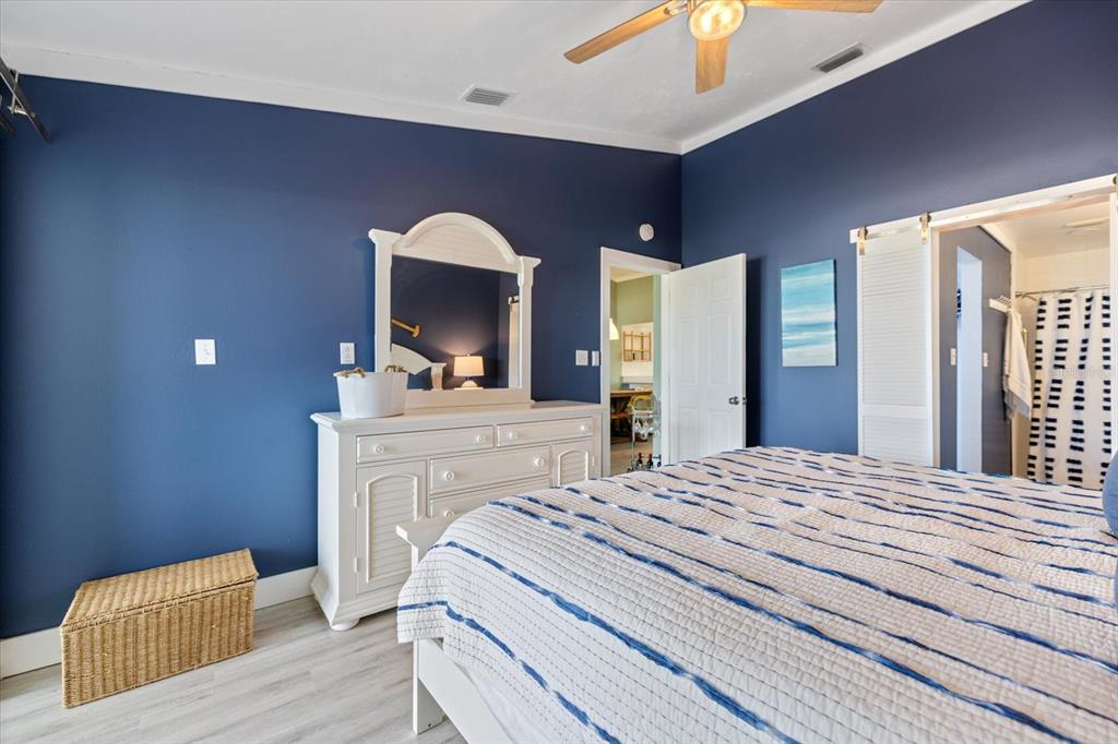 841 Waterside Drive, Unit 202 Venice, FL 34285 - Photo 28 of 43 a bedroom with a bed and a chandelier